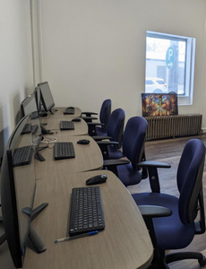 Computers with chairs in an office