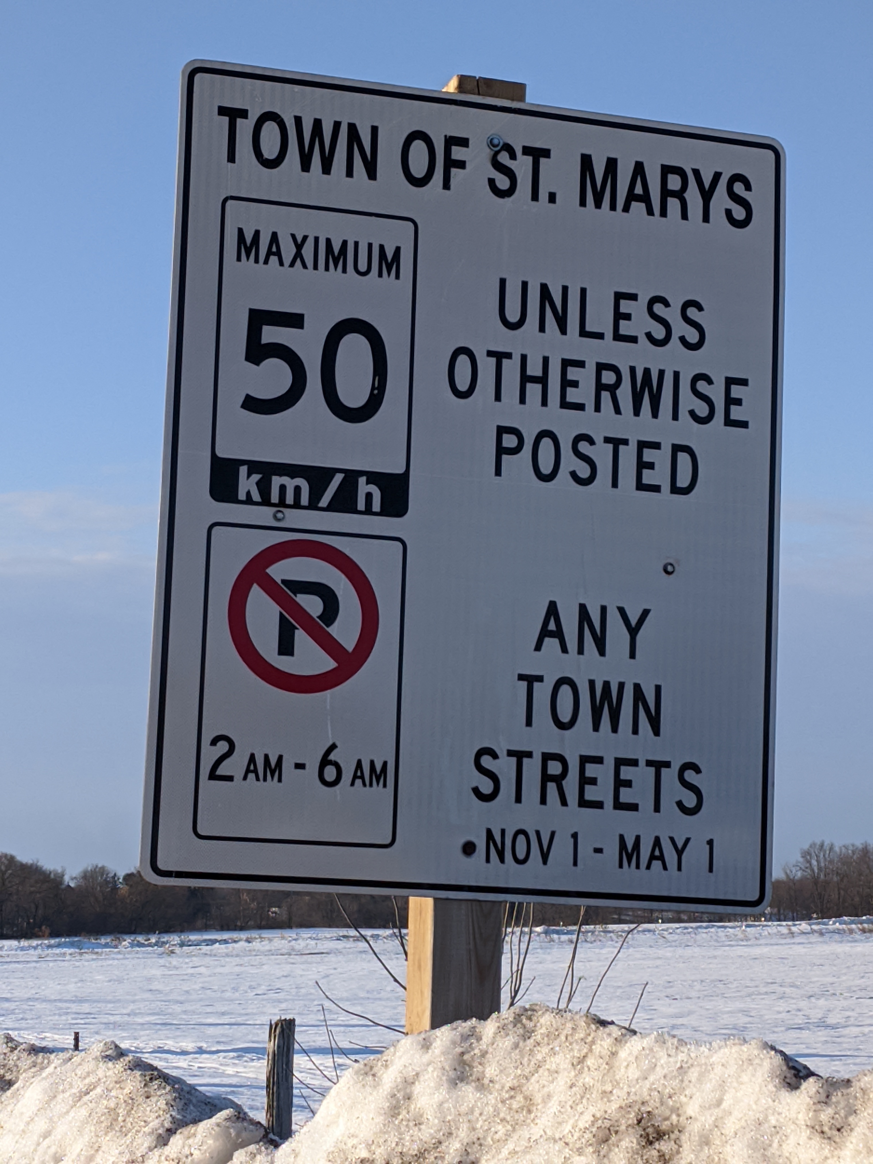 Image of street sign listing parking restrictions