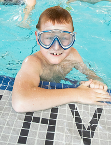 Boy wearing goggles in pool