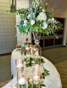 Flower and candle display on a table at a wedding