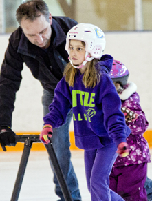 Girls and father skating