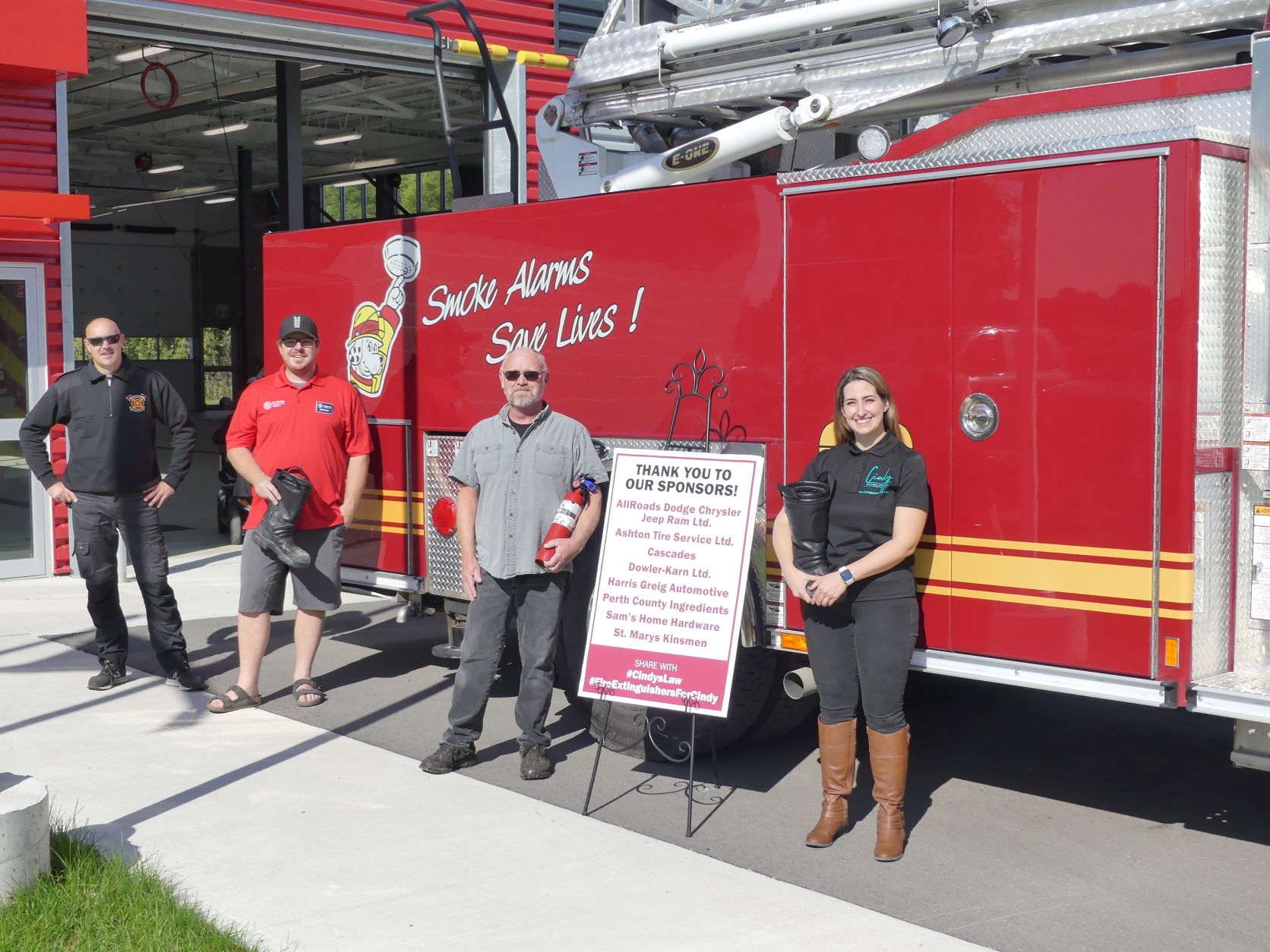 (From left to right) Firefighter Jim Burlingham, Kinsmen President Brent Foley, Lorne Culbert and Christine Rozon (the late Cindy Devine’s sister) stand proudly outside the St. Marys Fire Station where they, along with several other volunteers, handed out 120 fire extinguishers on October 2. 