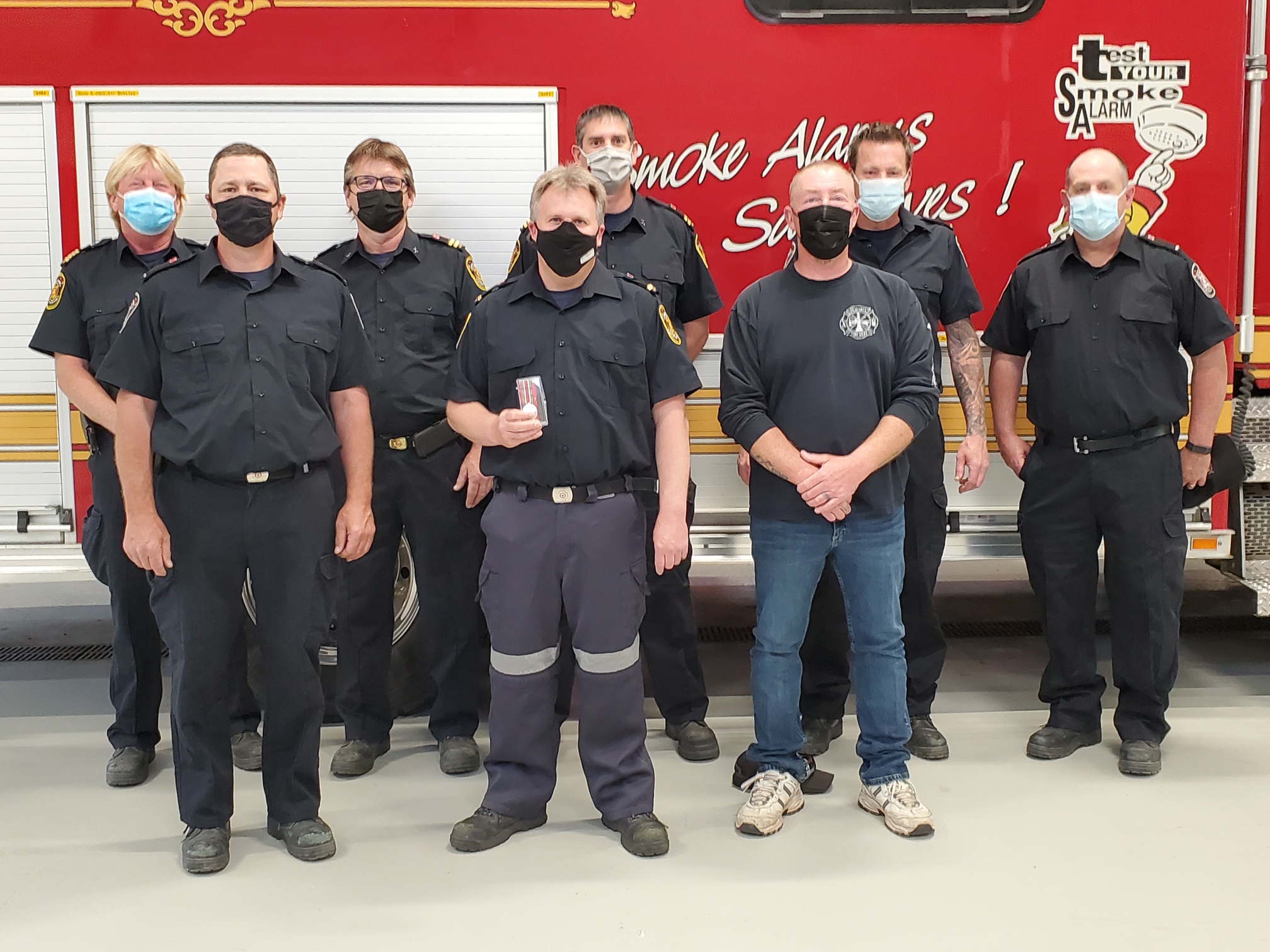 Firefighters standing with awards