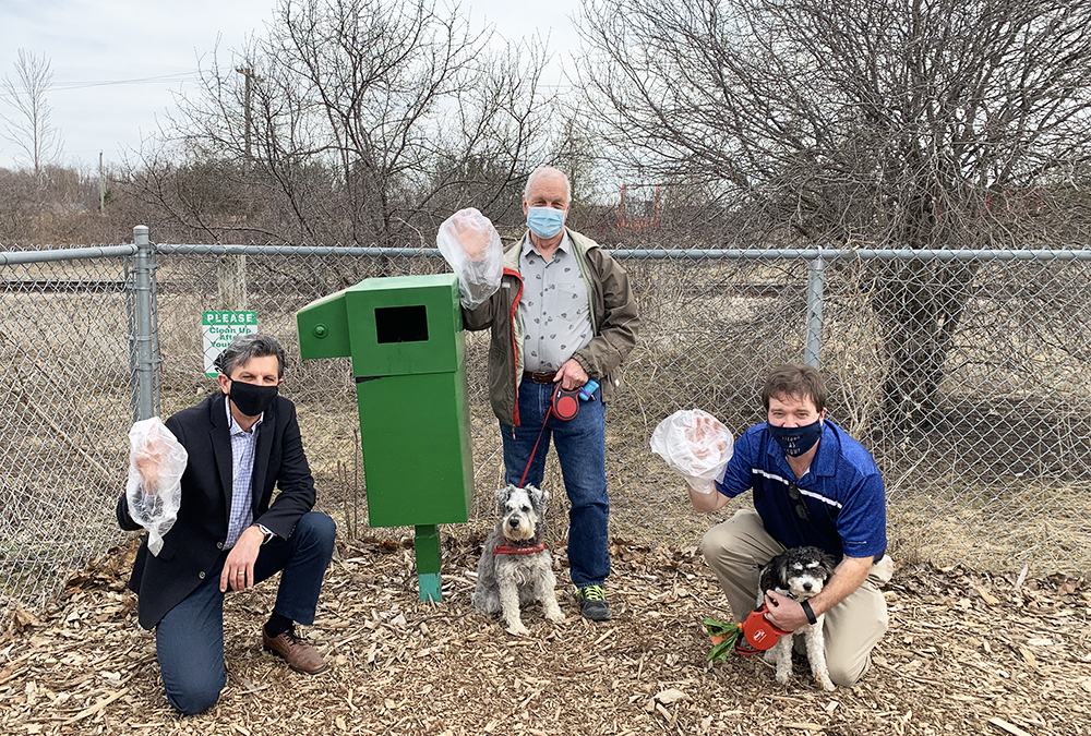 From left, Rick Culbert, Robert Linton (with miniature schnauzer Eli), and Mayor Al Strathdee (with his cockapoo Patsy) demonstrate that no one is above cleaning up after their dogs.