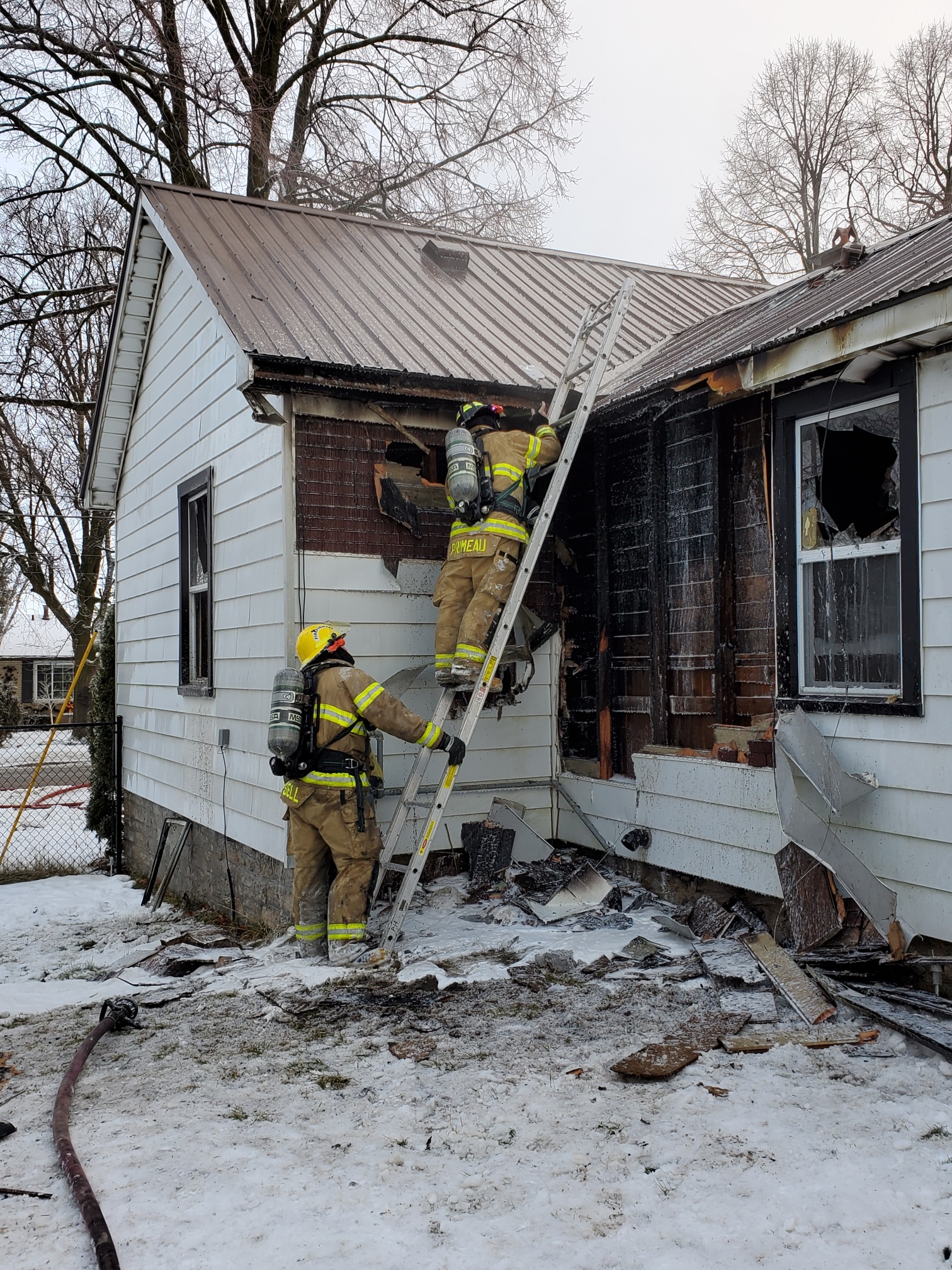 Two St. Marys Firefighters investigate the cause of the recent house fire at 500 Queen Street East.