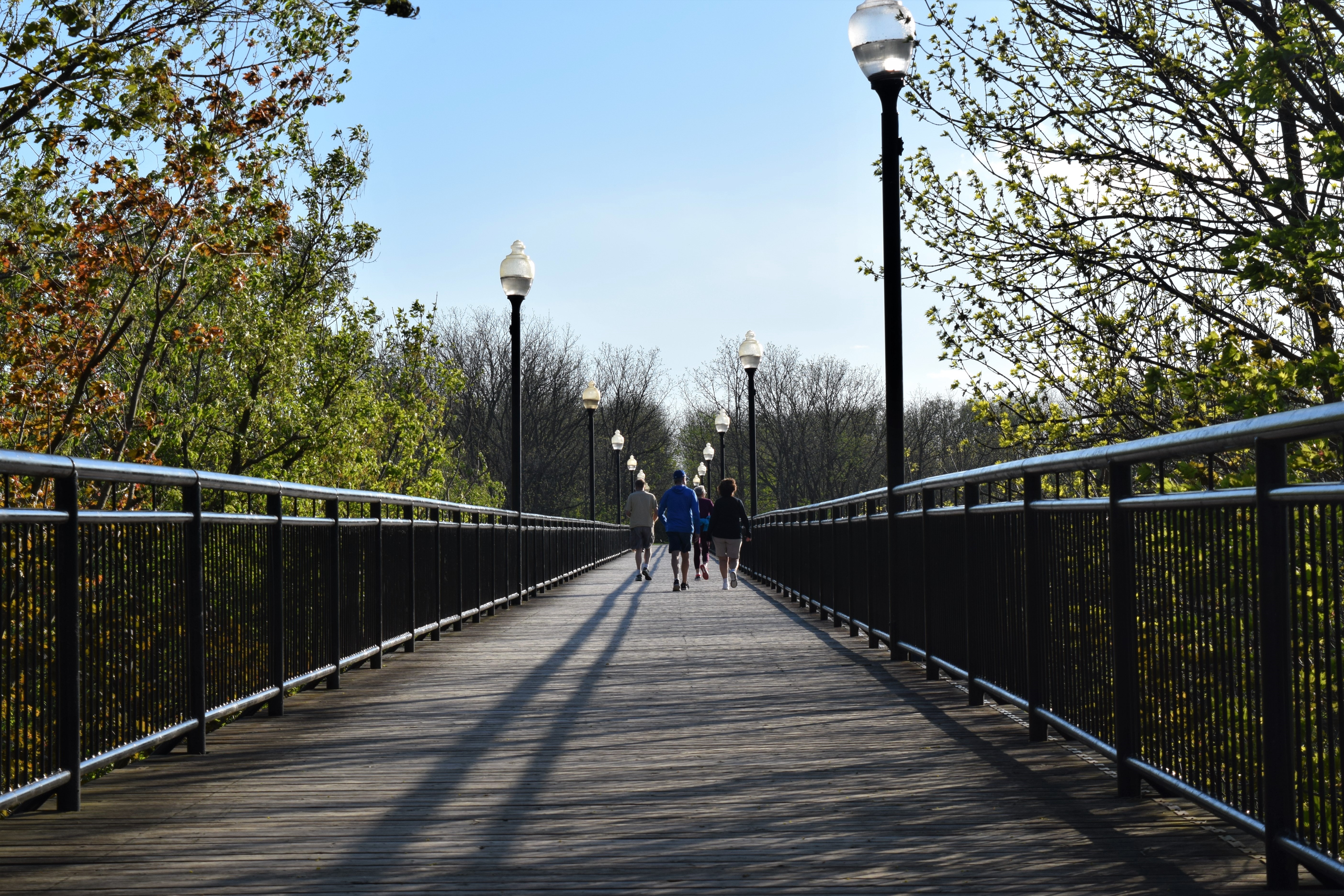 People walking on trestle bridge