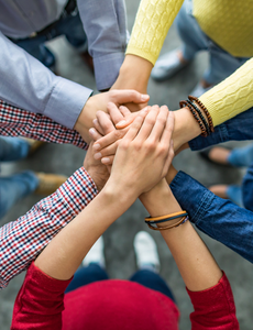 Group of people with joined hands