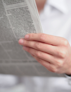 Image of woman reading newspaper
