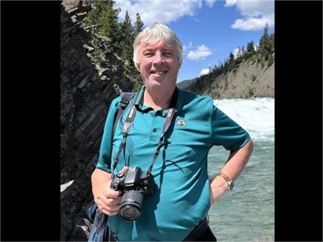 Photographer Patrick Payton posing with camera